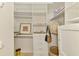 Bright walk-in closet with custom shelving, drawers, and ample space for storage at 124 Ventana Way, Venice, FL 34292