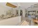 Bright dining area featuring chandelier, tiled floor and view through to the outdoor living space at 124 Ventana Way, Venice, FL 34292