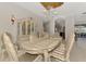 Classic dining room with large table, display cabinet, elegant chandelier, and plenty of natural light at 124 Ventana Way, Venice, FL 34292