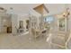 Formal dining room with decorative chandelier, tile flooring, and view to the front entry at 124 Ventana Way, Venice, FL 34292
