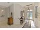 Spacious entry foyer with decorative tile flooring, columned features and a large chandelier at 124 Ventana Way, Venice, FL 34292