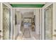 Elegant foyer with decorative glass doors, tile flooring, and views into the living space at 124 Ventana Way, Venice, FL 34292