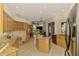 Spacious eat-in kitchen features custom cabinets, granite counters, tile flooring, and stainless steel appliances at 124 Ventana Way, Venice, FL 34292