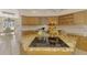 Kitchen island with granite counters and a flat cooktop overlooks a breakfast nook area at 124 Ventana Way, Venice, FL 34292