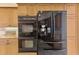Modern kitchen featuring black stainless steel appliances and custom cabinetry at 124 Ventana Way, Venice, FL 34292
