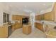 Well-lit kitchen with tile floors, built-in oven, wooden cabinetry, and granite countertops at 124 Ventana Way, Venice, FL 34292