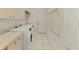 Bright laundry room features tile floors, white cabinets, and new Samsung washer and dryer at 124 Ventana Way, Venice, FL 34292
