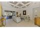 Bright living room features a coffered ceiling and sliding glass doors to a screened-in porch at 124 Ventana Way, Venice, FL 34292