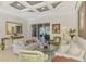 Cozy living room with tile flooring, neutral walls, and sliding glass doors to the outside at 124 Ventana Way, Venice, FL 34292