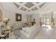 Elegant living room with tile flooring, stylish furnishings, and coffered ceiling with recessed lights at 124 Ventana Way, Venice, FL 34292