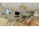 Spacious living room with access to the lanai and a view of the golf course at 124 Ventana Way, Venice, FL 34292