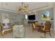 Open-concept living room with dining area, ceiling fan, and view of the golf course at 124 Ventana Way, Venice, FL 34292