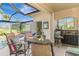 Outdoor bar with seating overlooks a pool with adjacent outdoor grill and golf course at 124 Ventana Way, Venice, FL 34292