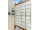 Outdoor shower showcasing a glass block wall and convenient corner shelving for toiletries and bathroom accessories at 124 Ventana Way, Venice, FL 34292