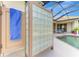 Enclosed outdoor shower with glass block wall, next to the screened pool area at 124 Ventana Way, Venice, FL 34292