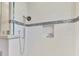 Detail of the shower with white tile, decorative accent stripe, and built-in niche at 124 Ventana Way, Venice, FL 34292