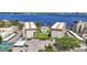 Stunning aerial view of a waterfront condo community with a pool and lush landscaping near the bay at 1600 1St W Ave # 304A, Bradenton, FL 34205