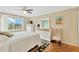 Relaxing bedroom with soft colors, fan, and natural light, complemented by wooden parquet floors at 1600 1St W Ave # 304A, Bradenton, FL 34205