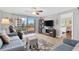 Cozy living room with comfortable seating, ceiling fan, and access to the outdoor balcony at 1600 1St W Ave # 304A, Bradenton, FL 34205