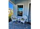 Cozy front porch featuring white wicker chairs and a charming view of the neighborhood at 25532 Royal Tern Ln, Englewood, FL 34223