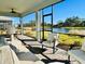 Screened lanai featuring brick pavers, comfortable seating, and peaceful water views at 25532 Royal Tern Ln, Englewood, FL 34223