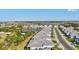 A high angle view showcases houses along a neighborhood street and large pond in the background at 2722 Sapphire Blue Ln, Bradenton, FL 34211