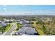 Aerial view showcasing the neighborhood's beautiful landscaping, houses, and scenic pond at 2722 Sapphire Blue Ln, Bradenton, FL 34211