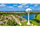 Aerial view of a residential neighborhood with a lake and distinctive community water tower at 2722 Sapphire Blue Ln, Bradenton, FL 34211