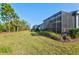 Large backyard surrounded by trees and green foliage, and featuring a screened patio at 2722 Sapphire Blue Ln, Bradenton, FL 34211