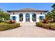 Attractive community clubhouse featuring elegant architecture, a tile roof, and manicured landscaping at 2722 Sapphire Blue Ln, Bradenton, FL 34211