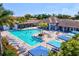 Resort-style community pool with palm trees, shaded seating, and pristine pool deck at 2722 Sapphire Blue Ln, Bradenton, FL 34211