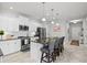 Modern kitchen with stainless steel appliances, white cabinetry, dark countertops, and a large center island at 2722 Sapphire Blue Ln, Bradenton, FL 34211