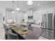 Modern kitchen featuring a large island with seating, stainless steel appliances, and white cabinets at 2722 Sapphire Blue Ln, Bradenton, FL 34211