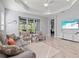Comfortable living room featuring a large sofa, marble tile flooring, and an open concept layout at 2722 Sapphire Blue Ln, Bradenton, FL 34211