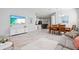 Open concept living room with marble tile floors, dining area, and a view into the kitchen at 2722 Sapphire Blue Ln, Bradenton, FL 34211