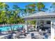 Inviting community pool area with poolside seating, a covered pavilion, and lush tropical landscaping at 2722 Sapphire Blue Ln, Bradenton, FL 34211