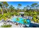 Relaxing community pool area with palms, ample seating, and a poolside kitchen at 2722 Sapphire Blue Ln, Bradenton, FL 34211