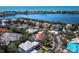 An aerial view captures the home's location, showcasing a pool and surrounding properties with waterfront views in the distance at 3540 Bayou Cir, Longboat Key, FL 34228