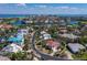 Expansive aerial view of a waterfront home with a red tile roof and lush landscaping in a desirable coastal community at 3540 Bayou Cir, Longboat Key, FL 34228