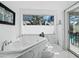 A soaking tub is situated below a window, offering natural light and privacy at 3540 Bayou Cir, Longboat Key, FL 34228