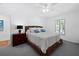 The light-filled bedroom features a ceiling fan, a nightstand with a lamp, and a comfy bed at 3540 Bayou Cir, Longboat Key, FL 34228