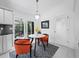 Breakfast nook with white marble table and two chairs. View of outdoor area with sliding glass doors at 3540 Bayou Cir, Longboat Key, FL 34228