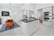 Bright eat-in kitchen features stainless steel appliances, custom cabinets, an island, and white tile flooring at 3540 Bayou Cir, Longboat Key, FL 34228