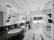 The luxurious main bathroom has double sinks, large mirrors, a glass shower, and a separate soaking tub at 3540 Bayou Cir, Longboat Key, FL 34228