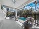 Screened-in patio with outdoor furniture and a view of the pool and backyard at 3540 Bayou Cir, Longboat Key, FL 34228