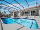 Stunning pool area with an enclosed lanai, offering a perfect outdoor living space at 3540 Bayou Cir, Longboat Key, FL 34228