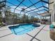 Beautiful enclosed pool with comfortable seating and tropical views, ideal for relaxation at 3540 Bayou Cir, Longboat Key, FL 34228