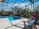 Enclosed pool and patio area with lounge chairs, grill, and lush landscaping at 3540 Bayou Cir, Longboat Key, FL 34228