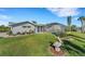 Lush backyard with screened lanai, canal view and lush landscaping at 4430 Wynkoop Cir, Port Charlotte, FL 33948