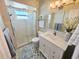 Updated bathroom featuring frameless shower, modern vanity, and decorative floor tiles at 4430 Wynkoop Cir, Port Charlotte, FL 33948